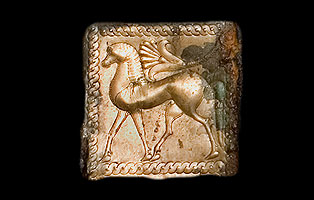 Particolare di una lamina in bronzo decorata a formelle con animali gradienti.